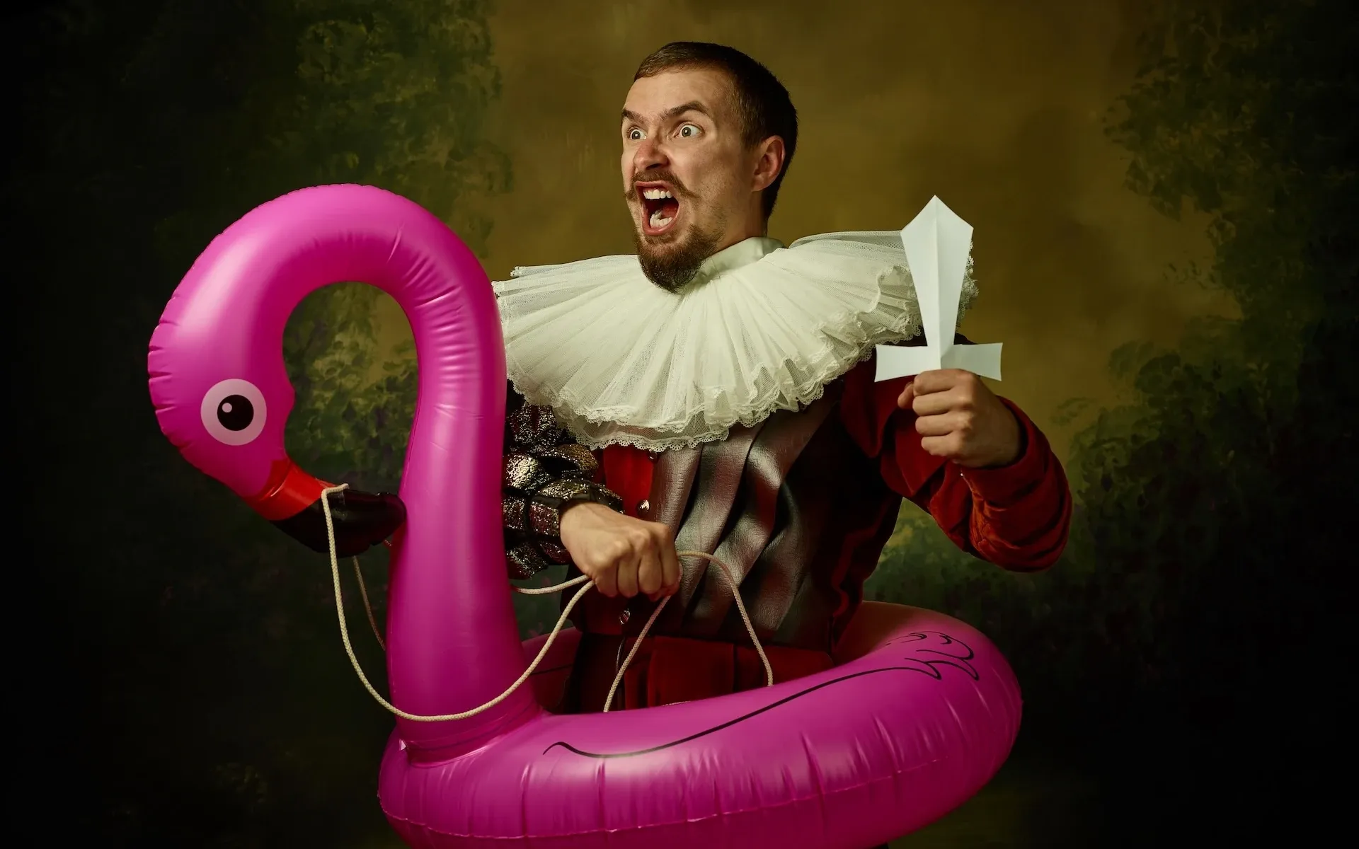 Man wearing Victorian clothes riding an inflatable flamingo 