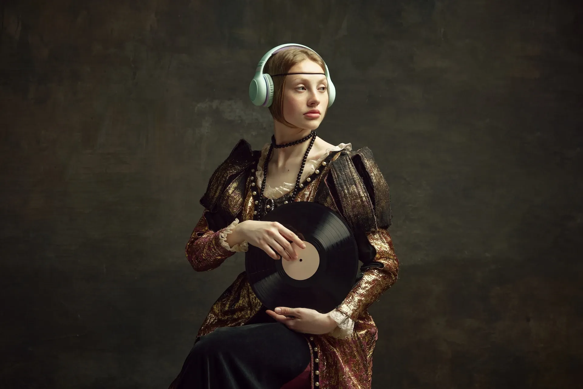 Woman in Victorian clothes wearing headphones and holding a record 