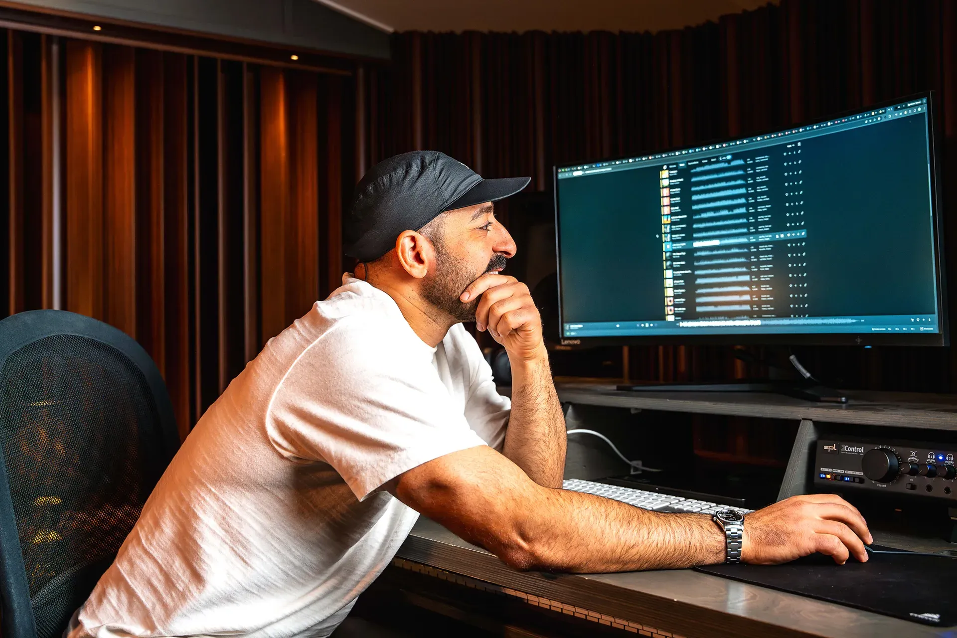A person sitting down and looking at tracks in Epidemic Sound Studio