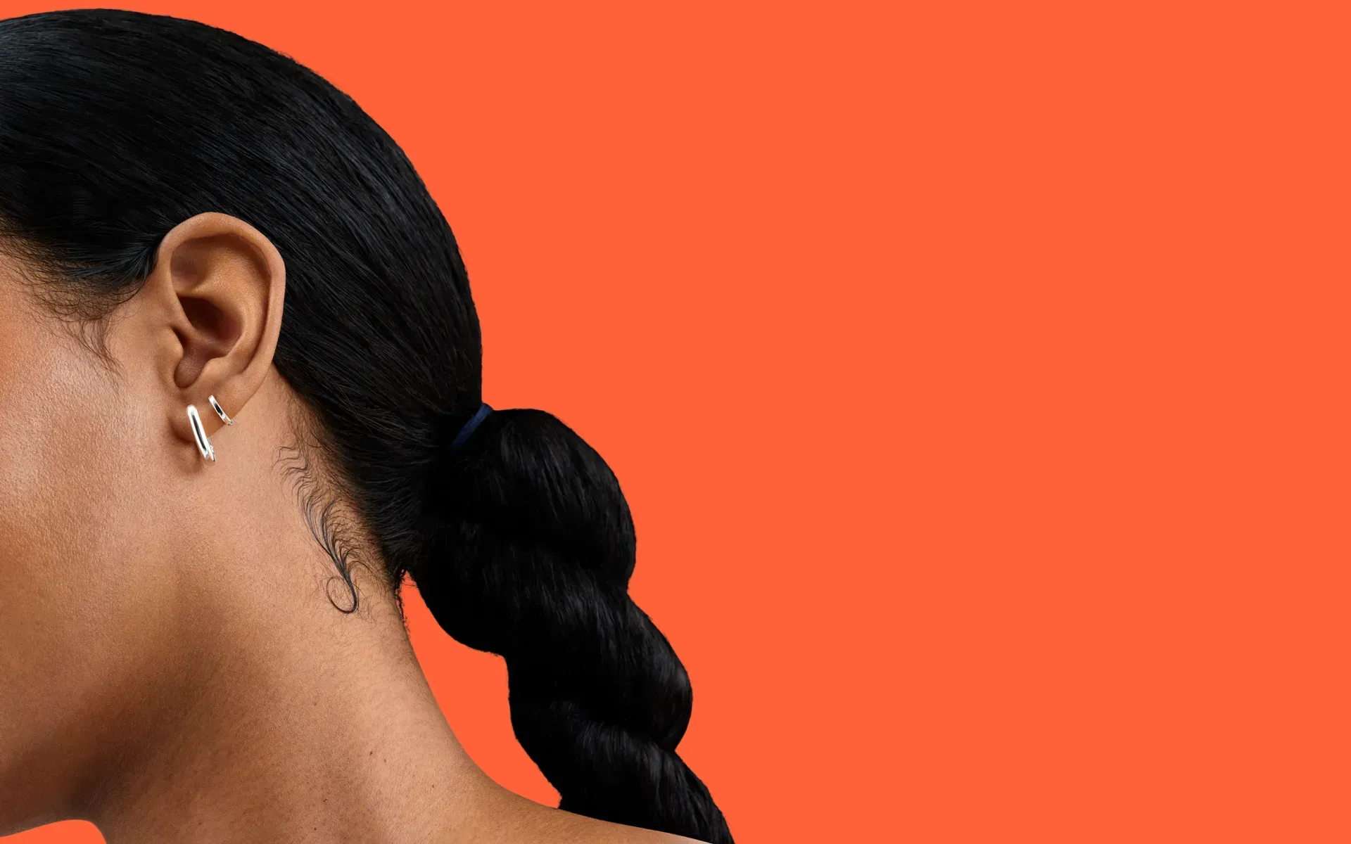 A close-up of a person’s neck and hair